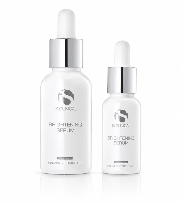 Two white glass serum bottles with droppers, labeled 'Brightening Serum' by iS CLINICAL, on a white background.
