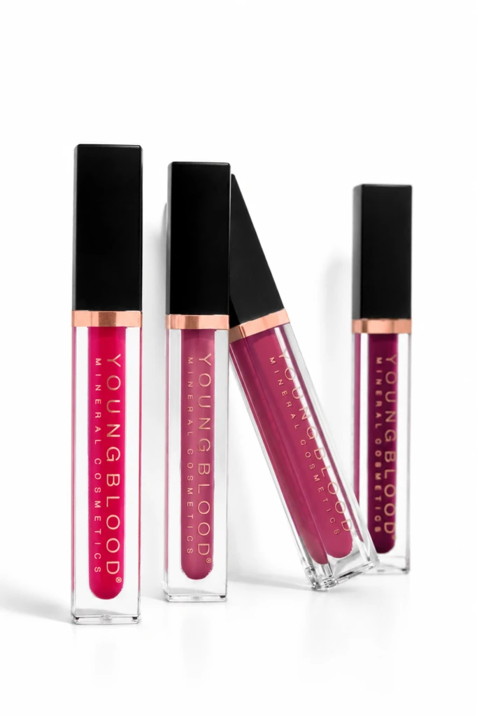 Four liquid lip gloss tubes with black caps and rose-gold bands, arranged on a white background.