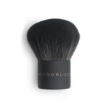 Close-up of a dense black makeup brush head with a dark handle visible at the bottom.