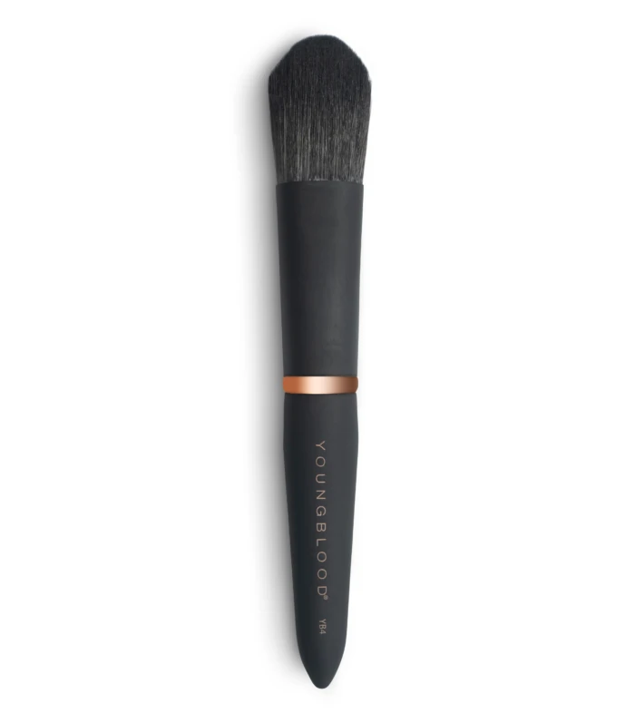 Close-up of a black makeup brush with dense bristles and a copper ferrule against a white background