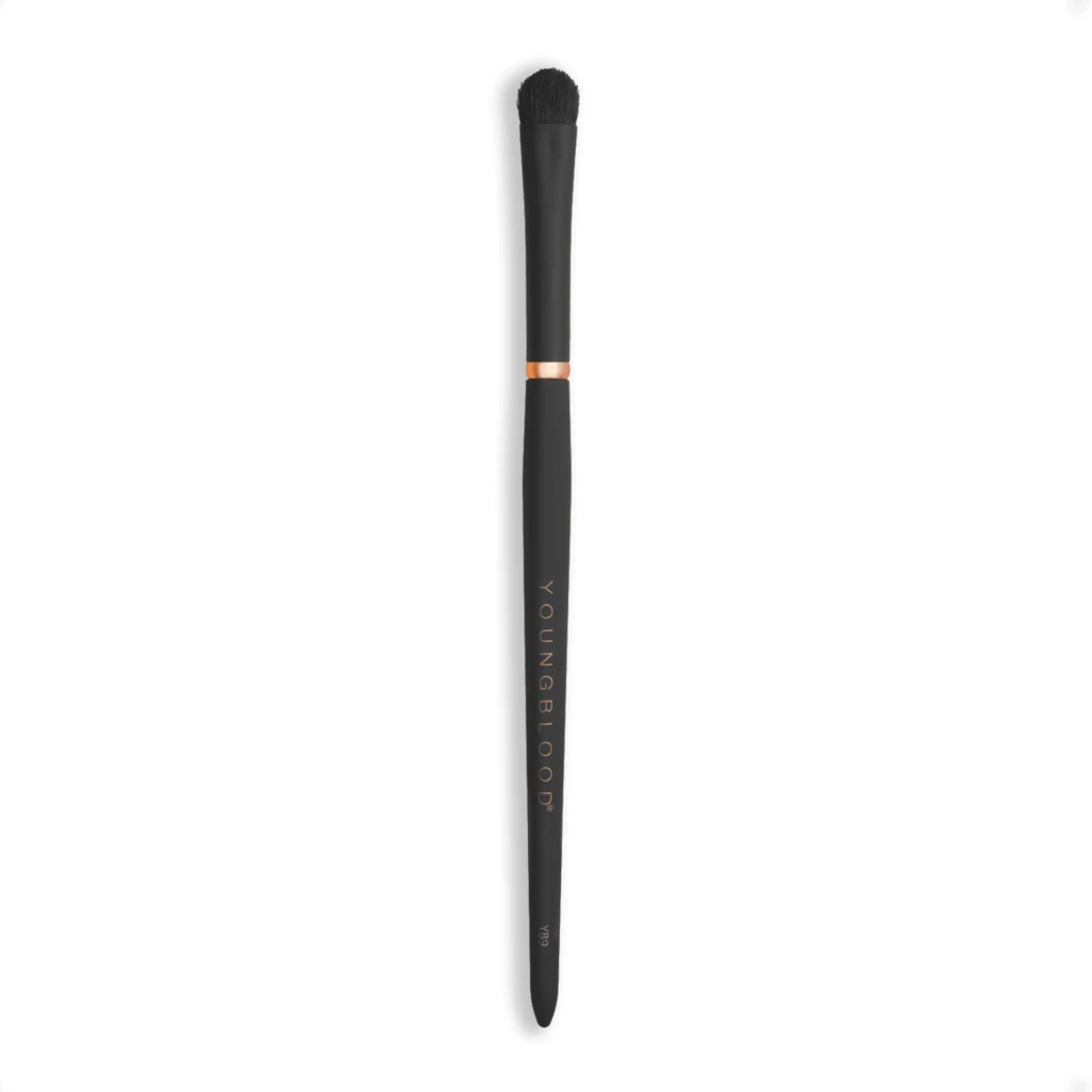 Vertical image of a black makeup brush with dense bristles against a white background; handle shows faint vertical text.