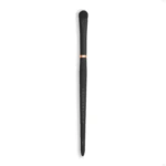 Vertical image of a black makeup brush with dense bristles against a white background; handle shows faint vertical text.