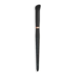 Black makeup brush with dense fluffy bristles, copper collar, and a dark handle against a white background