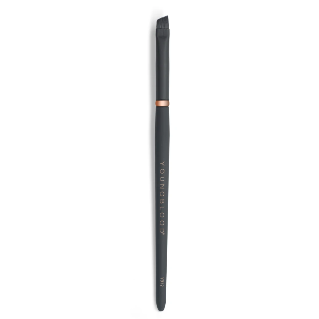 Vertical close-up of a black makeup brush with a copper ring, bristles at the top on a white backdrop.