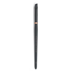 Vertical close-up of a black makeup brush with a copper ring, bristles at the top on a white backdrop.