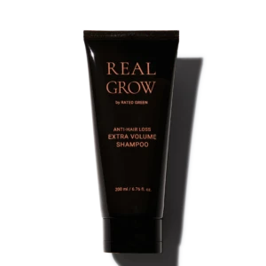 Tube of Real Grow anti-hair loss shampoo labeled 'EXTRA VOLUME'; 200 ml bottle with rose-gold text on black packaging