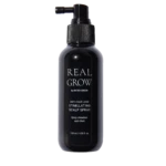 Dark spray bottle labeled REAL GROW anti-hair loss stimulating scalp spray against black background.