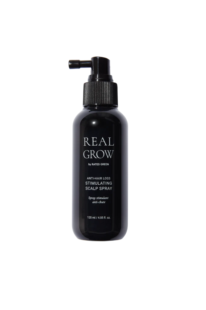 Dark spray bottle labeled REAL GROW anti-hair loss stimulating scalp spray against black background.