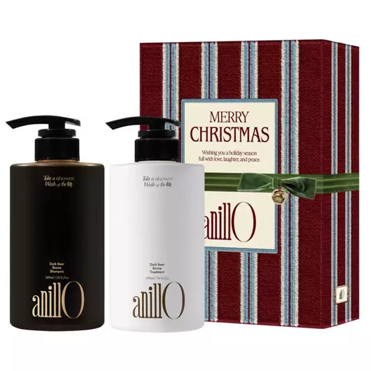 AnillO hair care gift set with two pump bottles beside a striped red Christmas gift box.