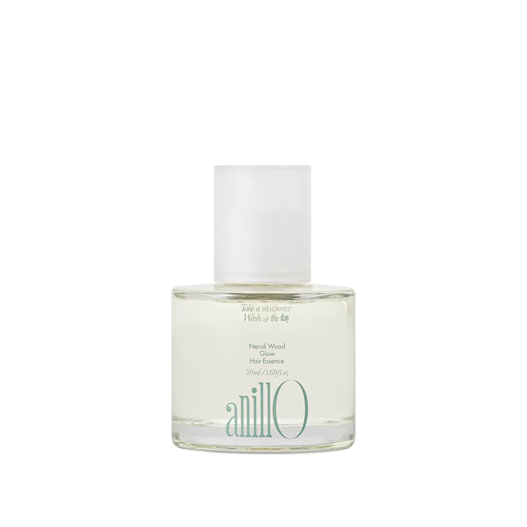 Bottle of Neroli Wood Glow Hair Essence by anillo, clear glass with a white cap on a light background.