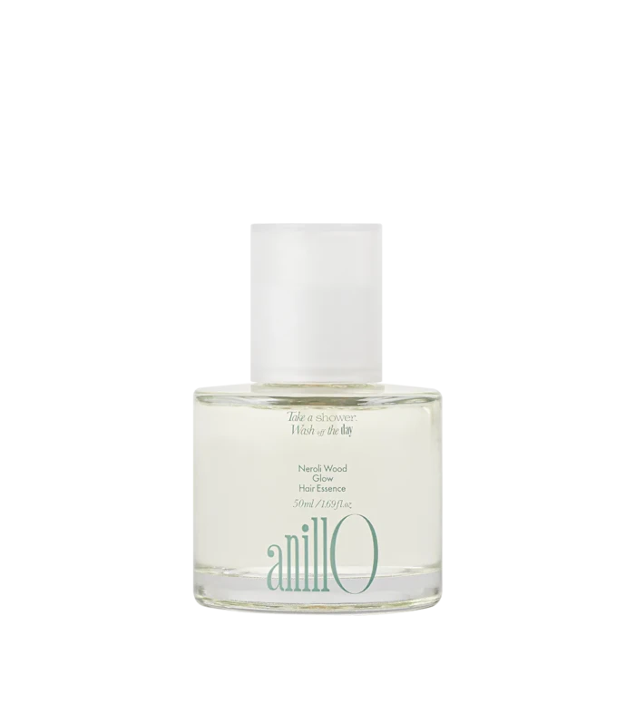Bottle of Neroli Wood Glow Hair Essence by anillo, clear glass with a white cap on a light background.