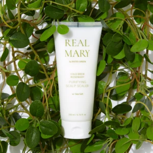 White tube labeled REAL MARY nestled among trailing green leaves and vines