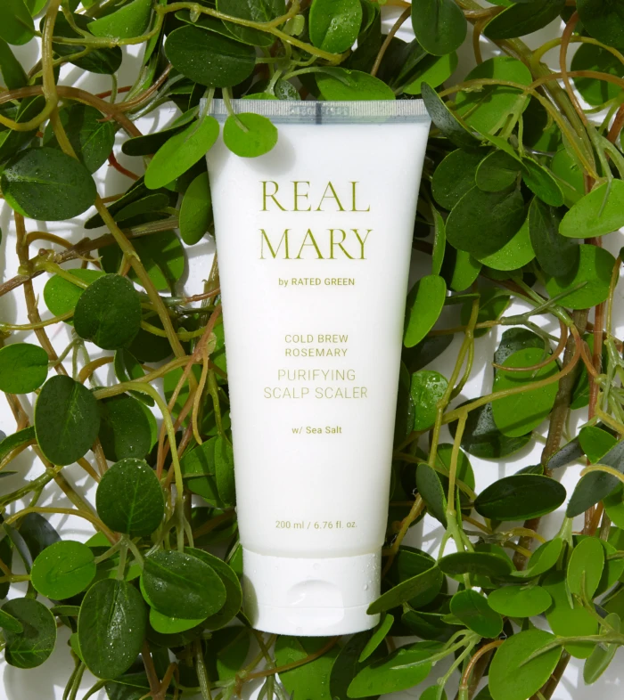 White tube labeled REAL MARY nestled among trailing green leaves and vines