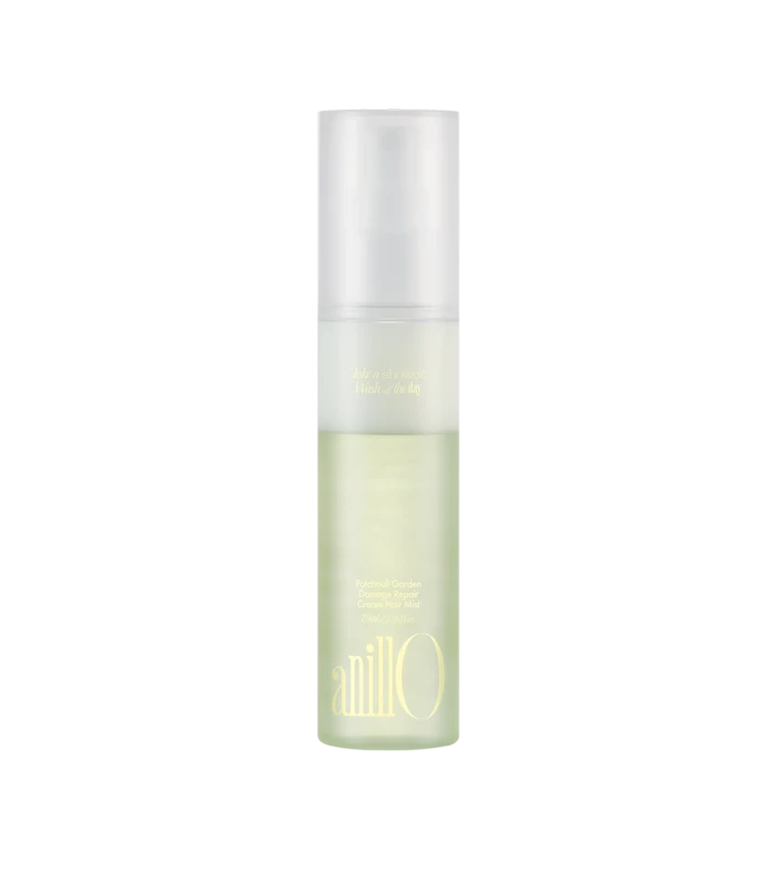 Tall frosted spray bottle with pale green liquid, labeled Patchouli Garden Damage Repair Cream Hair Mist.