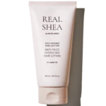 Tube of Real Shea anti-frizz hydrating hair lotion with jojoba oil, pale pink packaging in a vertical pose (150 ml).