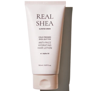 Tube of Real Shea anti-frizz hydrating hair lotion with jojoba oil, pale pink packaging in a vertical pose (150 ml).