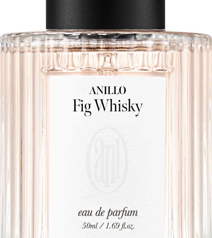 Perfume bottle with black cap and ribbed glass, label reads ANILLO Fig Whisky, eau de parfum, 50 ml