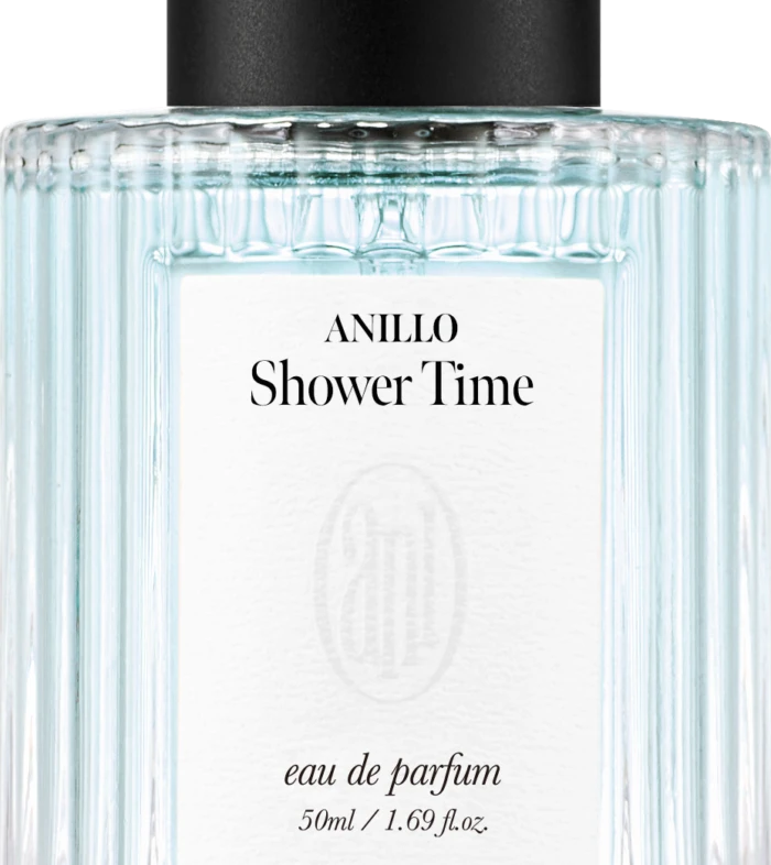Perfume bottle with ribbed clear glass, black cap, and label reading ANILLO Shower Time, eau de parfum, 50 ml/1.69 fl oz.