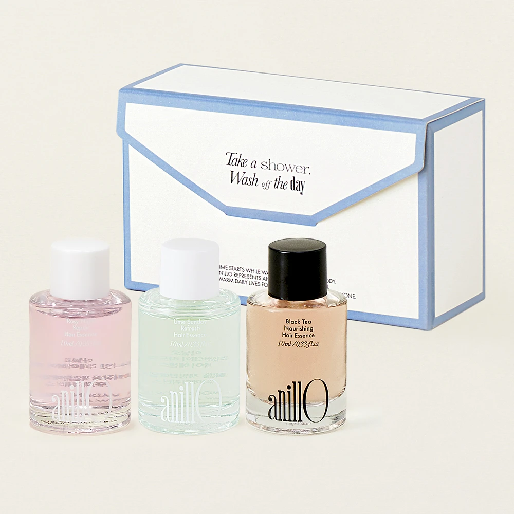 Three pastel nail polish bottles (pink, mint, nude) sit in front of a white and blue boxed set with an envelope design, suggesting a gift set.