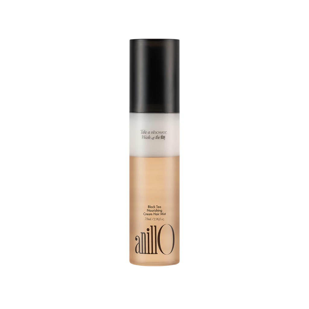 Bottle of AnillO Black Tea Nourishing Cream Hair Mist with a black cap and beige-tinted liquid at the base