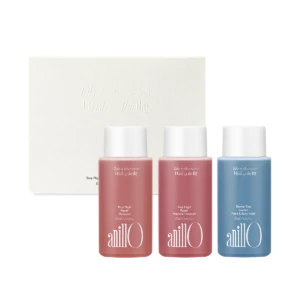Set of three AnillO bath products in pink and blue bottles in front of a white textured box with embossed text 'Take a shower, Wash off the day'.