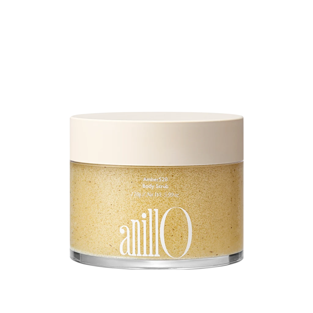 Jar of Amber528 Body Scrub with a pale beige lid; label shows 'Amber528 Body Scrub' and net weight, with a grainy beige scrub inside the clear container.