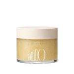 Jar of Amber528 Body Scrub with a pale beige lid; label shows 'Amber528 Body Scrub' and net weight, with a grainy beige scrub inside the clear container.