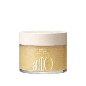 Jar of Amber528 Body Scrub with a pale beige lid; label shows 'Amber528 Body Scrub' and net weight, with a grainy beige scrub inside the clear container.