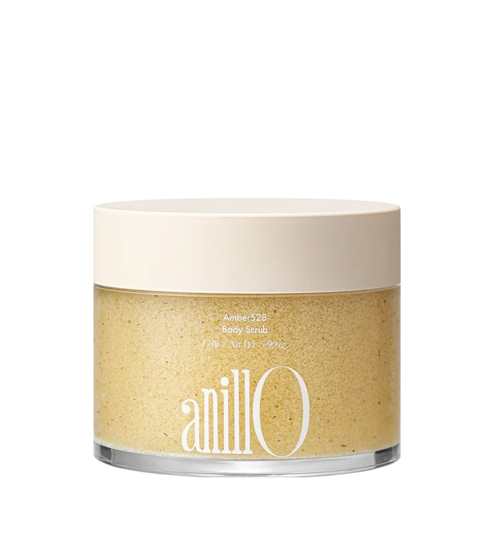 Jar of Amber528 Body Scrub with a pale beige lid; label shows 'Amber528 Body Scrub' and net weight, with a grainy beige scrub inside the clear container.