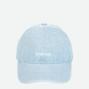 Close-up of a light blue denim cap from above, showing the top button and stitched panels with the word 'DARLING' on the back.