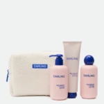 Products from the Darling brand arranged with a beige towel in the background; includes pink bottles with blue caps and a Pump dispenser, text visible on bottles.
