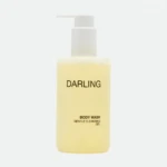 Pale yellow pump bottle labeled DARLING with a white pump, indicating body wash.