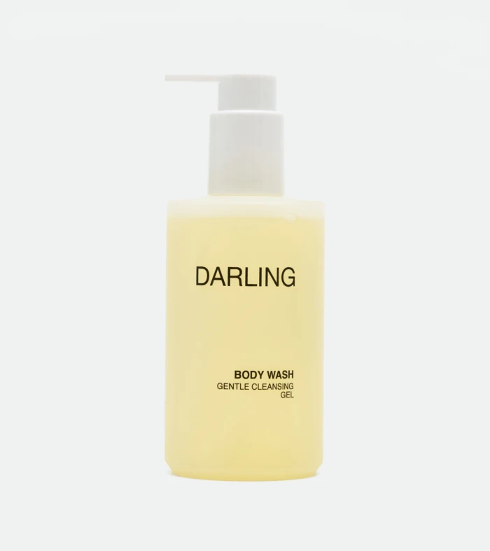 Pale yellow pump bottle labeled DARLING with a white pump, indicating body wash.