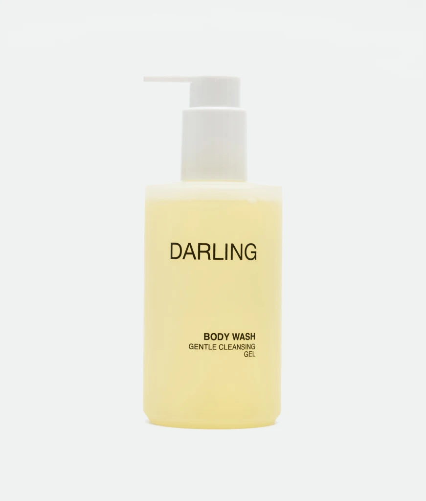 Pale yellow pump bottle labeled DARLING with a white pump, indicating body wash.