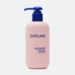 Close-up of a pink bottle with a blue pump, displaying the word 'DARLING' on the label.