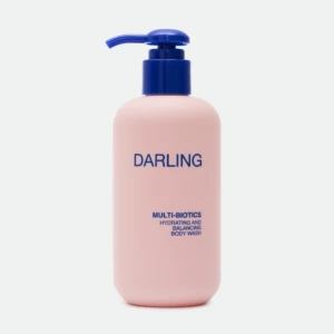Close-up of a pink bottle with a blue pump, displaying the word 'DARLING' on the label.