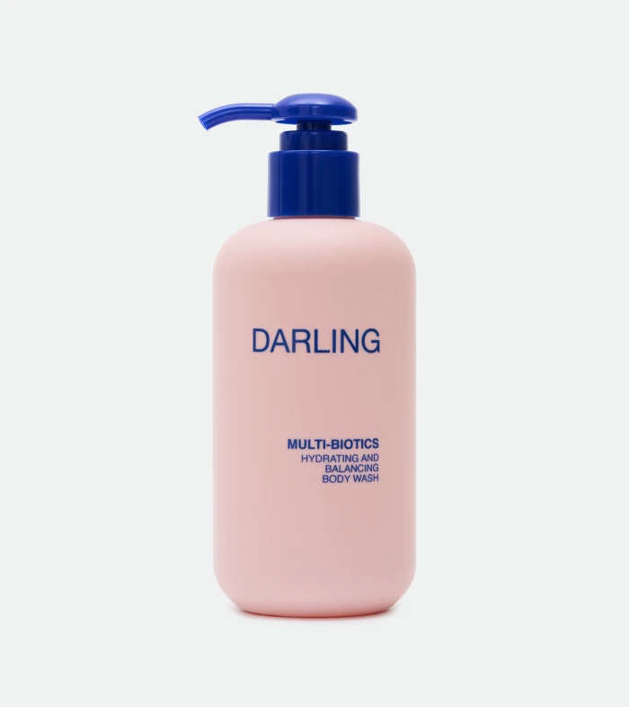 Close-up of a pink bottle with a blue pump, displaying the word 'DARLING' on the label.