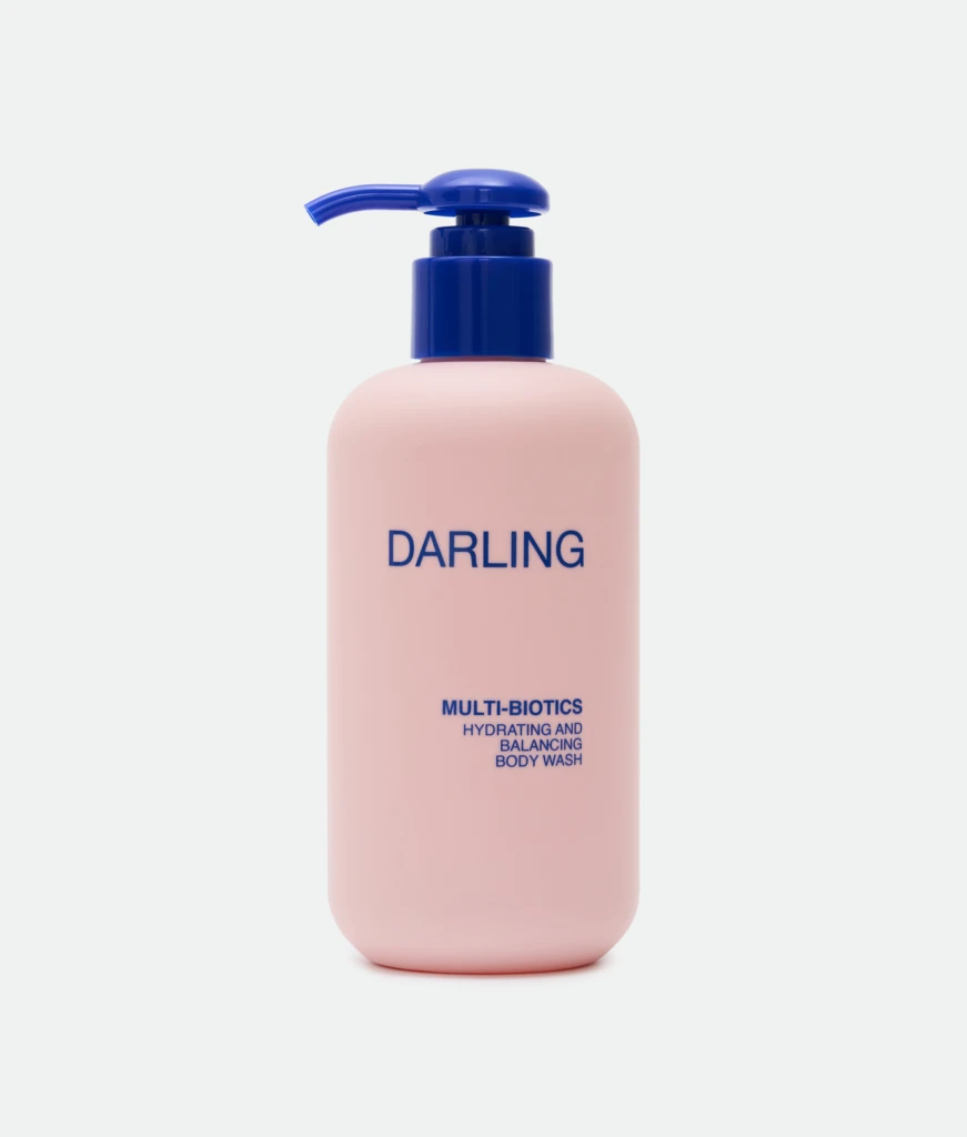 Close-up of a pink bottle with a blue pump, displaying the word 'DARLING' on the label.
