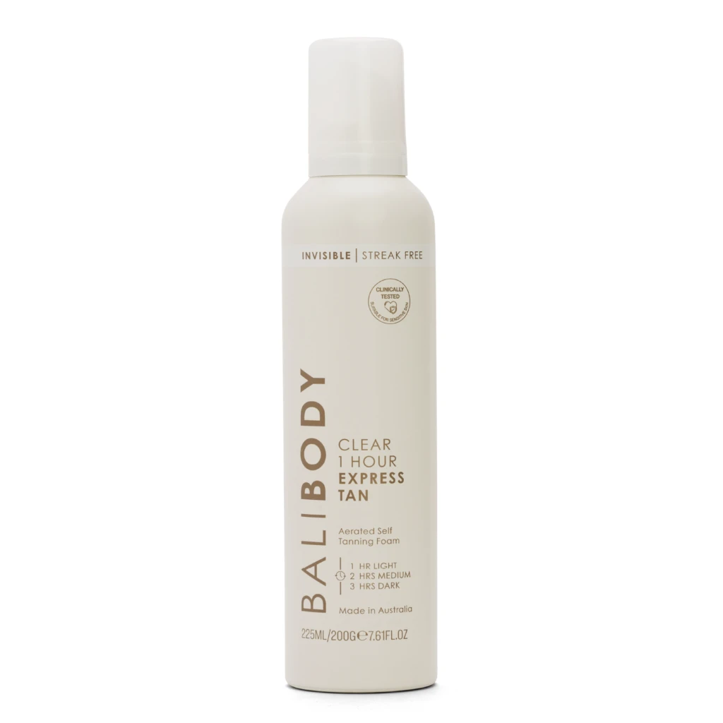 White lotion bottle with a tall, slim shape and a rounded cap; label reads 'Invisible Streak Free' and 'Clinically Tested' with cosmetic branding.