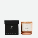 Black Salt & Stone box placed next to an amber candle jar with a white label reading 'SALT & STONE'.
