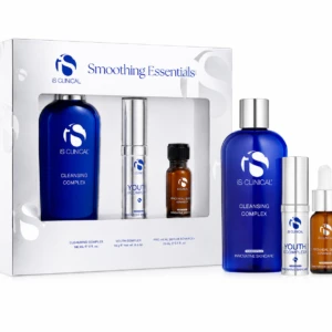 Boxed iS CLINICAL Smoothing Essentials skincare set with blue cleansing complex bottle and smaller serums visible beside the box, on a white background.