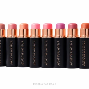 Row of black lipstick tubes with rose-gold caps in a line, showing pink to coral lipstick shades on a white background.