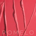 Close-up of a red glossy surface with wavy raised strands and the faint word POMELO at the bottom edge.