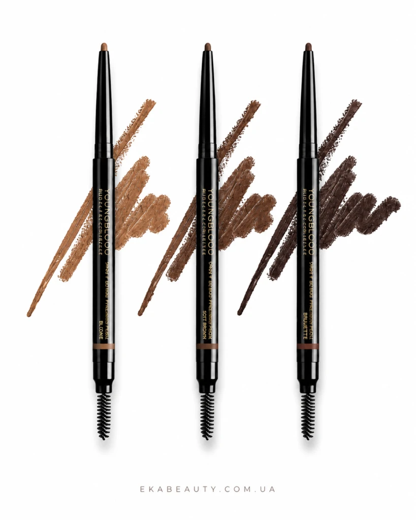 Three black YOUNGBLOOD cosmetic pencil eyeliners with brown, medium brown, and dark brown swatches behind them on a white background, with the website ekabeauty.com.ua at the bottom.