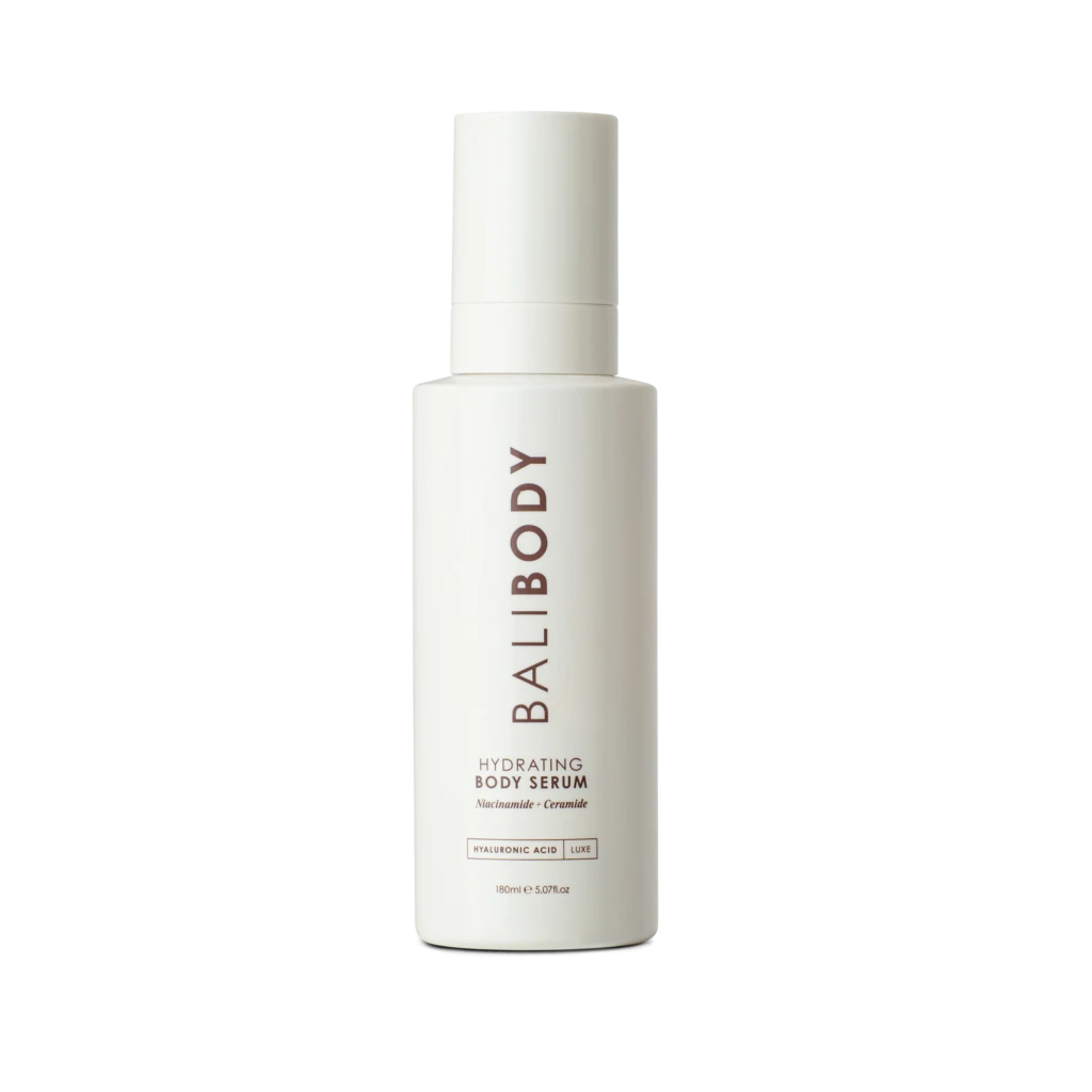 White skincare bottle centered on a black background; label reads Hydrating Body Serum with Niacinamide and Ceramide.