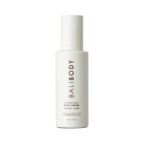 White skincare bottle centered on a black background; label reads Hydrating Body Serum with Niacinamide and Ceramide.