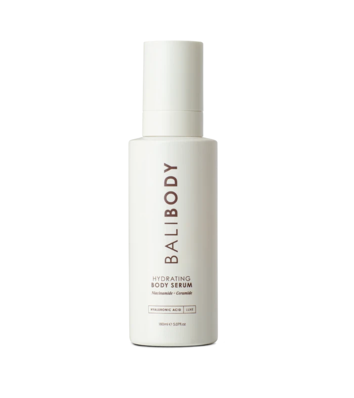 White skincare bottle centered on a black background; label reads Hydrating Body Serum with Niacinamide and Ceramide.