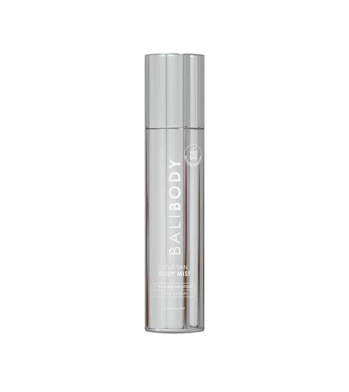Tall silver cylindrical bottle of Self Tan Body Mist with a circular DHA badge on the label