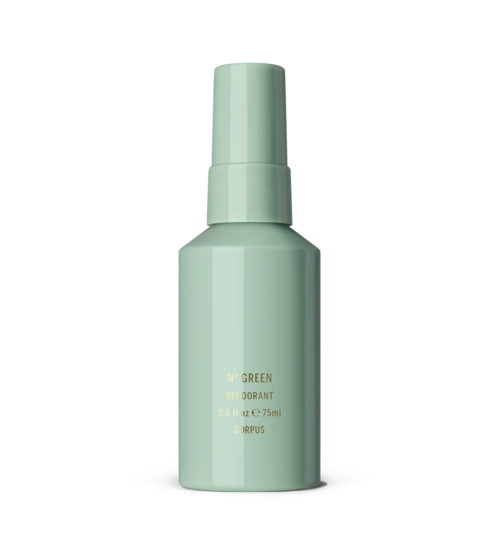 Mint-green deodorant bottle standing on a white surface, label with gold text visible (No Green Deodorant).