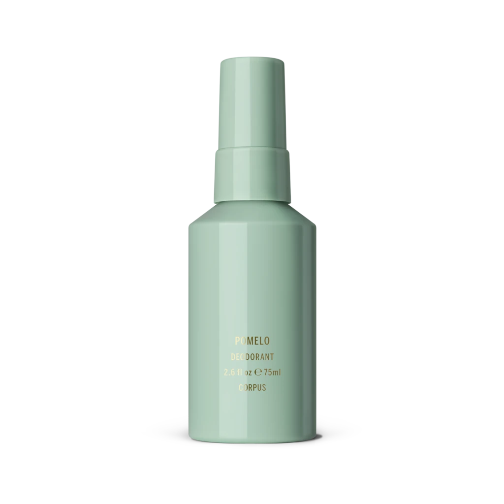 Mint green deodorant bottle with gold text reading POMELO on a gray surface.